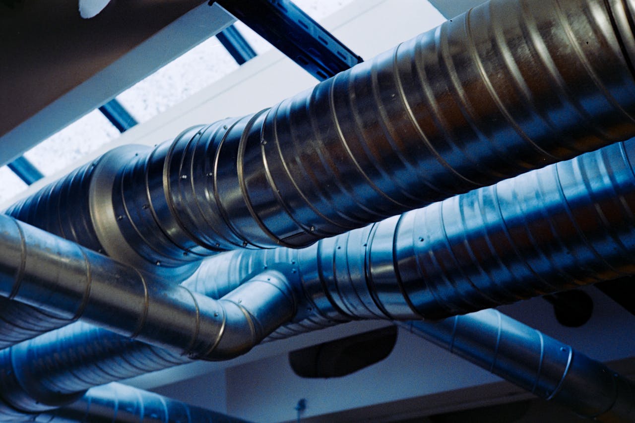services-02 Close-up of a modern metallic ventilation system in an industrial setting.